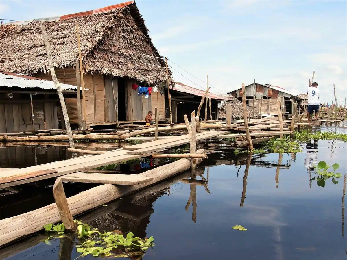 Amazon. Peru. Iquitos - Brown wooden house on body of water during daytime