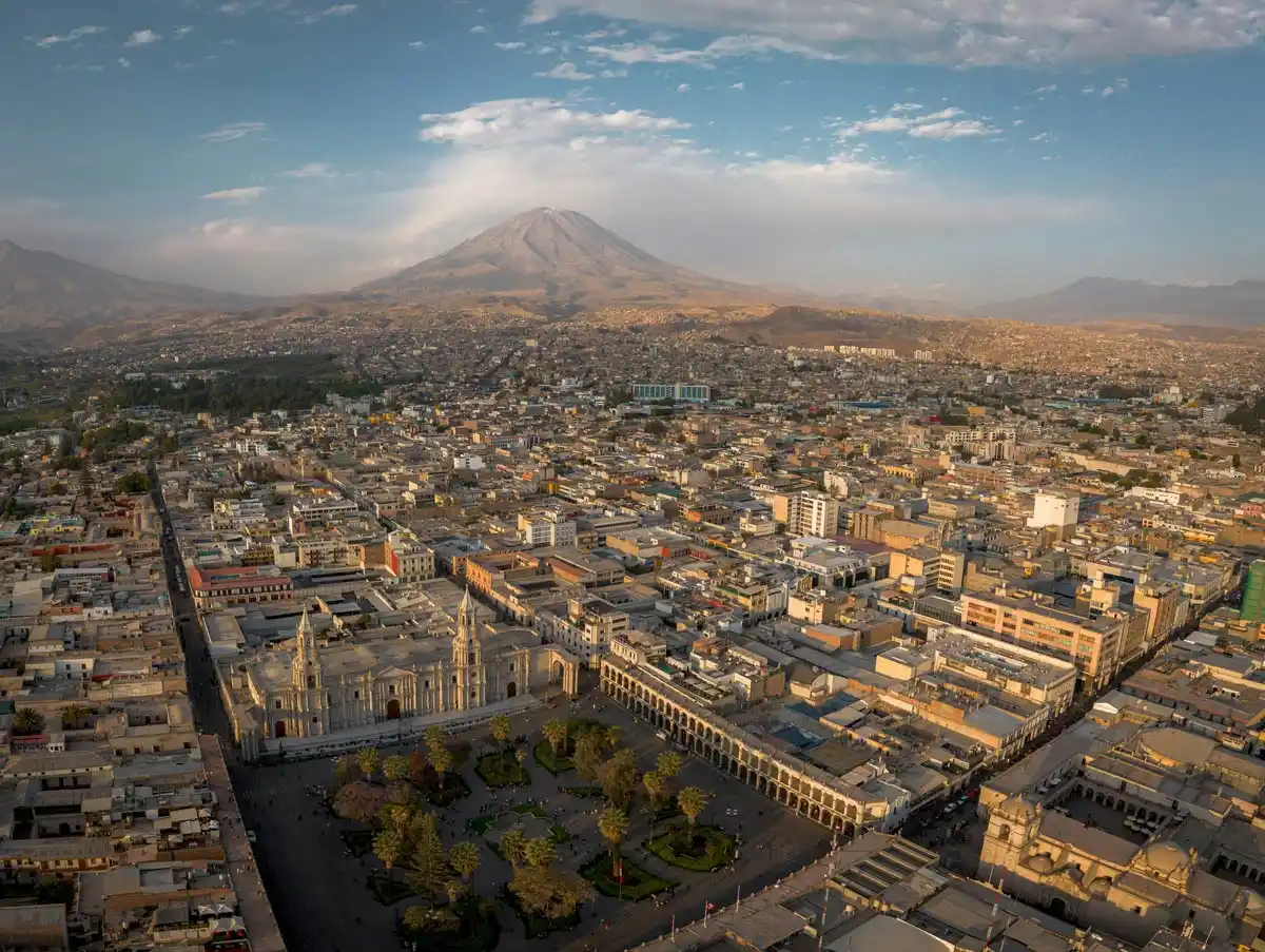 A panaromic shot of the city of Arequipa. The Basilica Cathedral in the city square and the Misti volcano are seen.